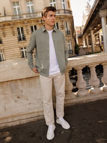 Green Jacket And Beige Pants Look