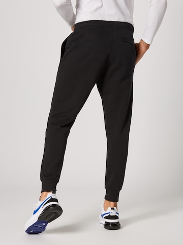 Nike Sportswear Tapered Trousers in Black: back