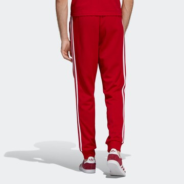 Effilé Pantalon 'Sst Tp' ADIDAS ORIGINALS en rouge