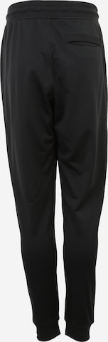 Effilé Pantalon de sport UNDER ARMOUR en noir