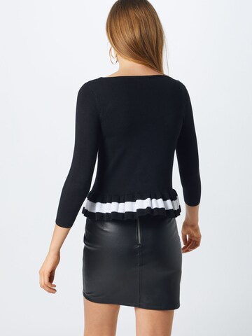 Pull-over GUESS en noir : derrière