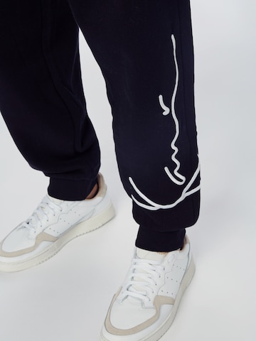 Karl Kani Tapered Trousers in Black