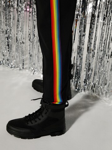 ABOUT YOU x Riccardo Simonetti Tapered Trousers in Black