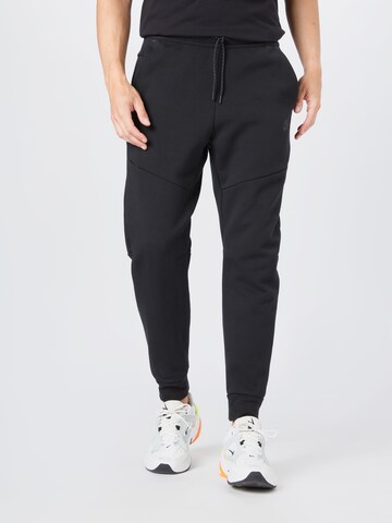 Nike Sportswear Tapered Pants in Black: front