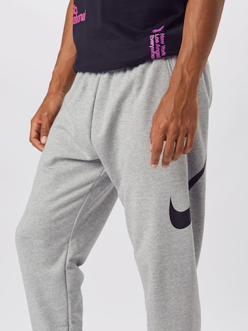 NIKE Tapered Sports trousers in Grey