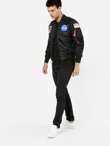 ALPHA INDUSTRIES Välikausitakki 'Nasa' värissä musta