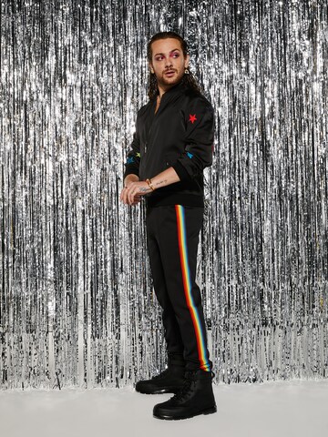 ABOUT YOU x Riccardo Simonetti Tapered Trousers in Black: front
