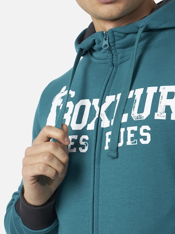 Boxeur des Rues - Sudadera 'Herren Hoodie Fitted Boxeur des Rues mit Reißverschluss und Kapuze, Petrolblau, Weißes Logo, Baumwolle' en azul