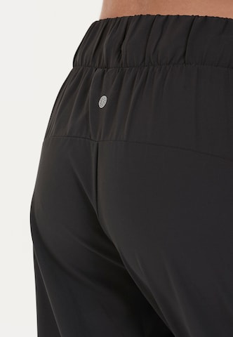 Athlecia - Tapered Pantalón deportivo 'Austberg' en negro