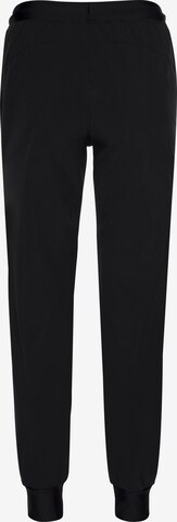 UNDER ARMOUR Tapered Sports trousers in Black