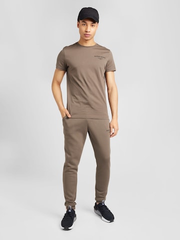 Tapered Pantaloni sport 'ESSENTIAL' de la BJÖRN BORG pe maro