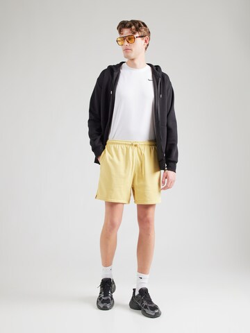 Nike Sportswear Loose fit Trousers 'CLUB' in Yellow
