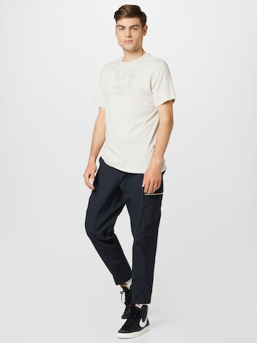 Tapered Pantaloni cu buzunare de la Nike Sportswear pe negru