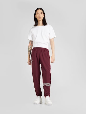NIKE Tapered Sports trousers 'FLSH CHLLGR' in Red