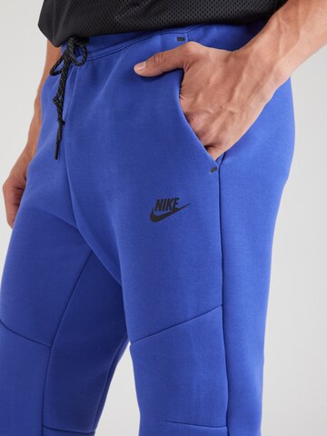 Nike Sportswear Tapered Broek 'TCH FLC' in Blauw