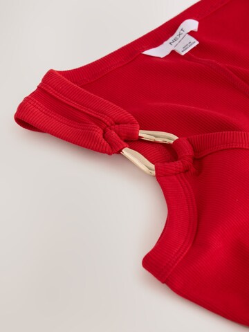 Next - Top en rojo