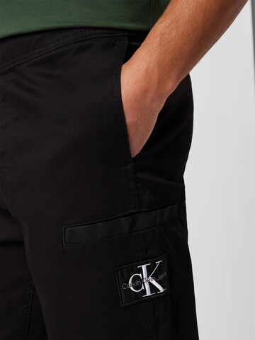 melns Calvin Klein Jeans Pakapēniski sašaurināts piegriezums Bikses