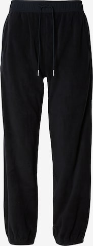 Calvin Klein Jeans Tapered Housut värissä musta: etupuoli