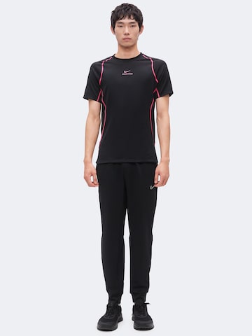 Effilé Pantalon de sport 'Flex' NIKE en noir