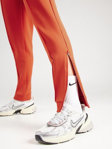 NIKE Tapered Sports trousers 'Heritage' in Brown