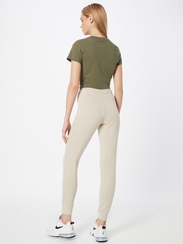 Nike Sportswear Tapered Trousers 'W NSW ESSNTL PANT TIGHT FLC' in Beige