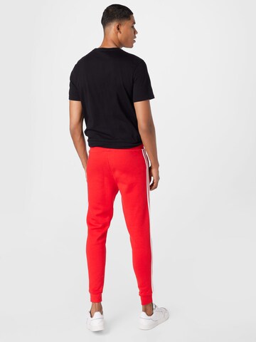 Effilé Pantalon ADIDAS ORIGINALS en rouge