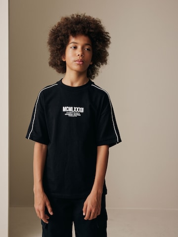 Next Majica | črna barva: sprednja stran