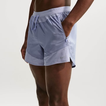 NIKE Regular Workout Pants 'Stride Nvlty' in Purple