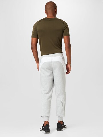 PUMATapered Sportske hlače 'Esports E7' - siva boja