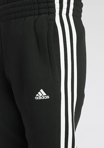 ADIDAS SPORTSWEAR Tapered Urheiluhousut 'Essentials' värissä musta