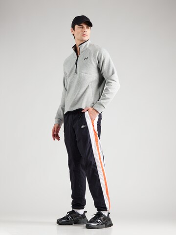 Effilé Pantalon de sport UNDER ARMOUR en noir