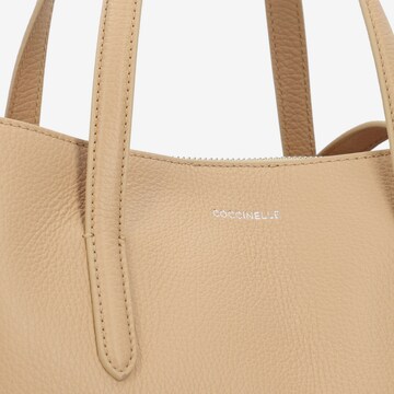 Coccinelle Handtasche 'Swap' in Beige