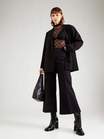 Wide leg Pantaloni con piega frontale di FRAME in nero
