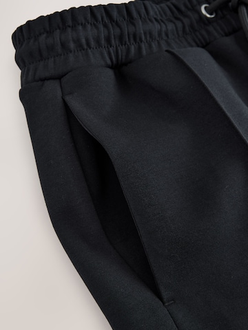 melns Next Standarta Bikses