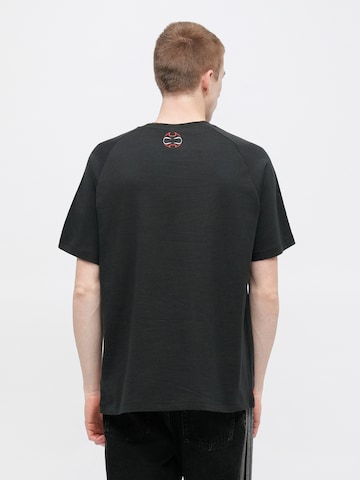 ADIDAS ORIGINALS Paita 'TEAMGEIST' värissä musta