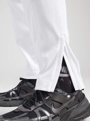 NIKE Zwężany krój Spodnie sportowe 'HERITAGE' w kolorze biały