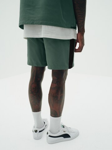 Sinned x ABOUT YOU Loose fit Trousers 'Victor' in Green