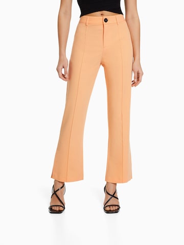 Bershka Flared Pants in Orange: front