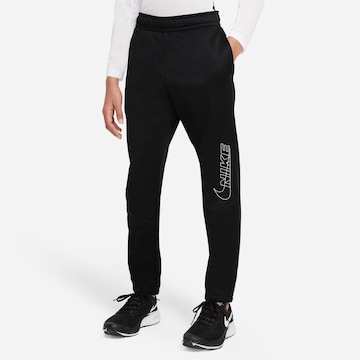 NIKE Tapered Sports trousers in Black: front