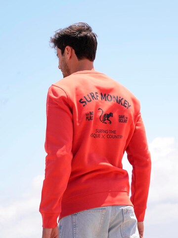 Surf Monkey - Sudadera 'Rette das Ozean' en rojo