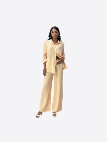 Elara Buksedragt i beige: forside