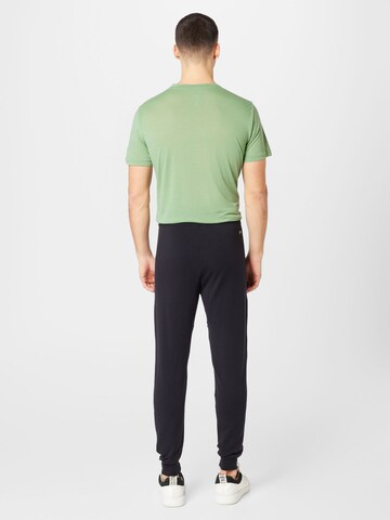 Tapered Pantaloni sportivi di super.natural in nero