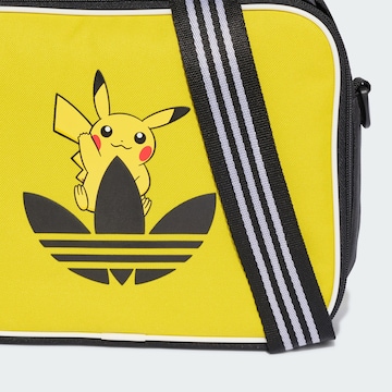 ADIDAS ORIGINALS - Recipiente de almacenamiento 'Pokemon' en amarillo