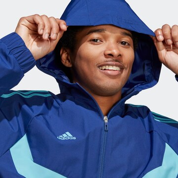 ADIDAS SPORTSWEAR - Casaco deportivo 'Tiro Warm' em azul