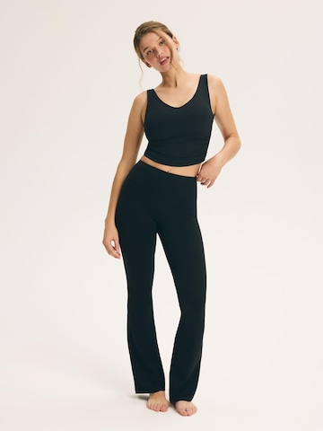 ESOTIQ Flared Pants 'KICK IT' in Black: front