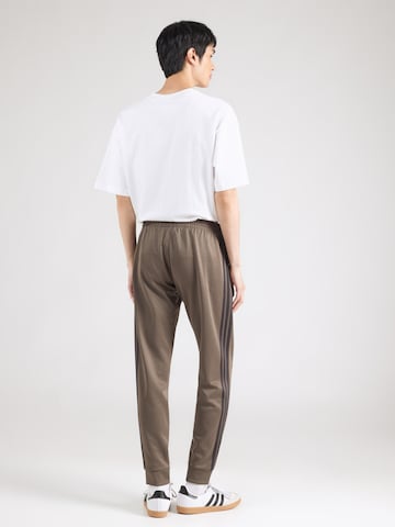 Tapered Pantaloni 'SST' de la ADIDAS ORIGINALS pe maro