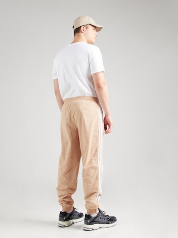 ADIDAS ORIGINALS - Tapered Pantalón 'Adicolor Firebird' en beige