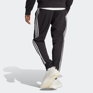 ADIDAS SPORTSWEAR Tapered Παντελόνι φόρμας 'Essentials' σε μαύρο