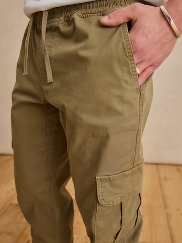 DAN FOX APPAREL Tapered Pants 'Mats' in Green