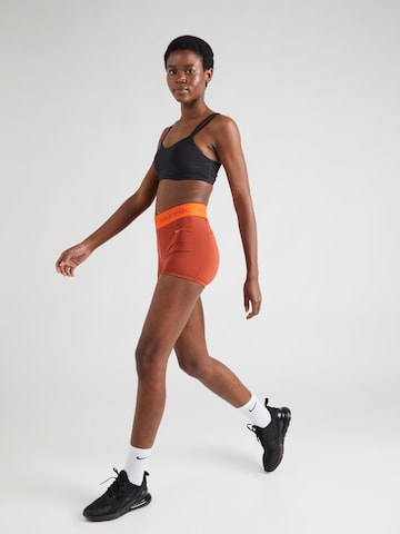 NIKE - Skinny Calças de desporto em laranja